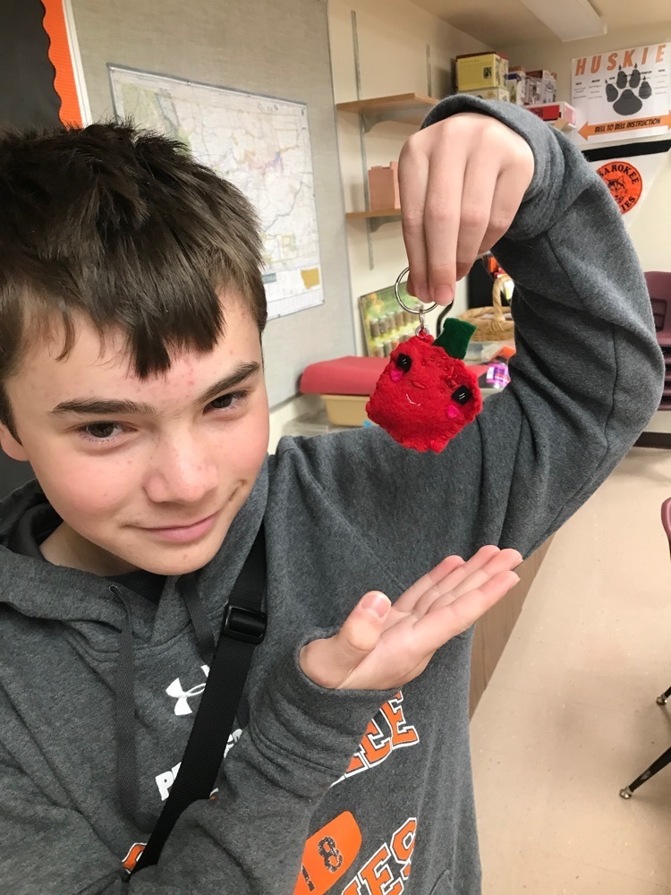 student holds pepper keychain