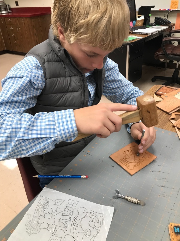 Student stamping leather