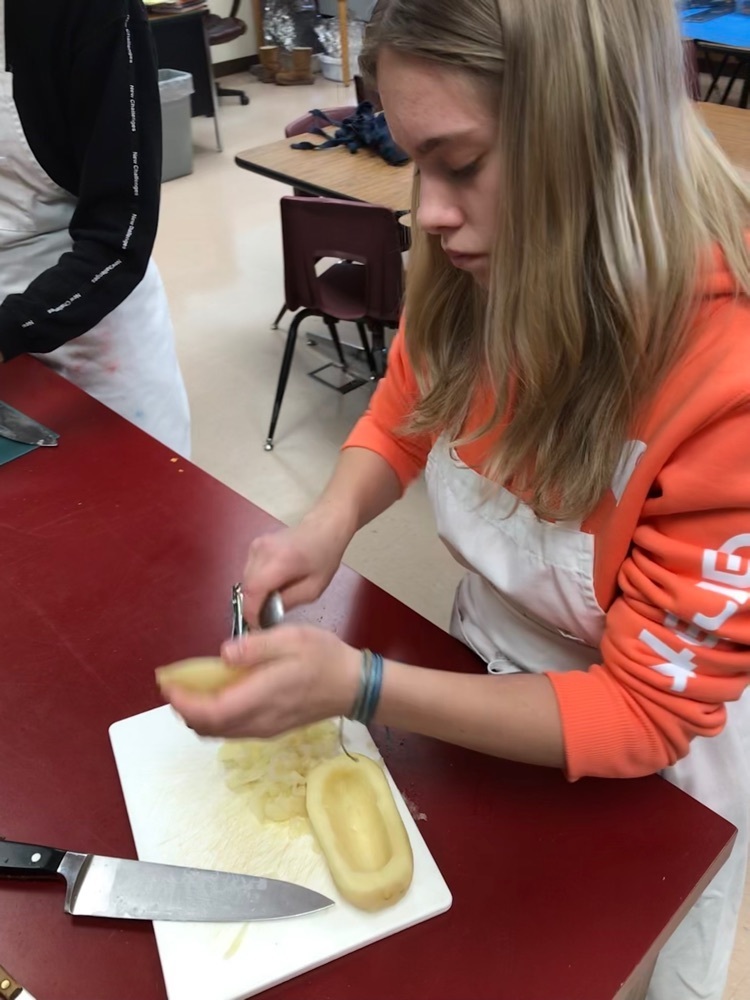 student prepares potato