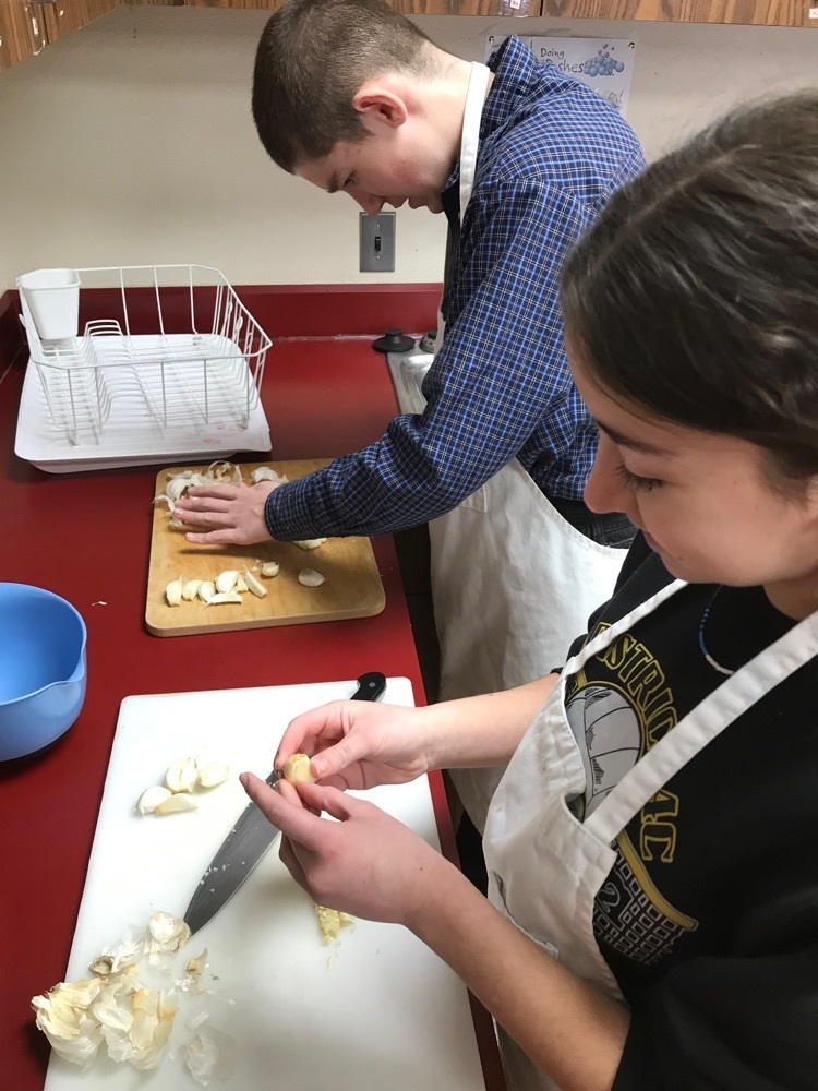 student prepares garlic