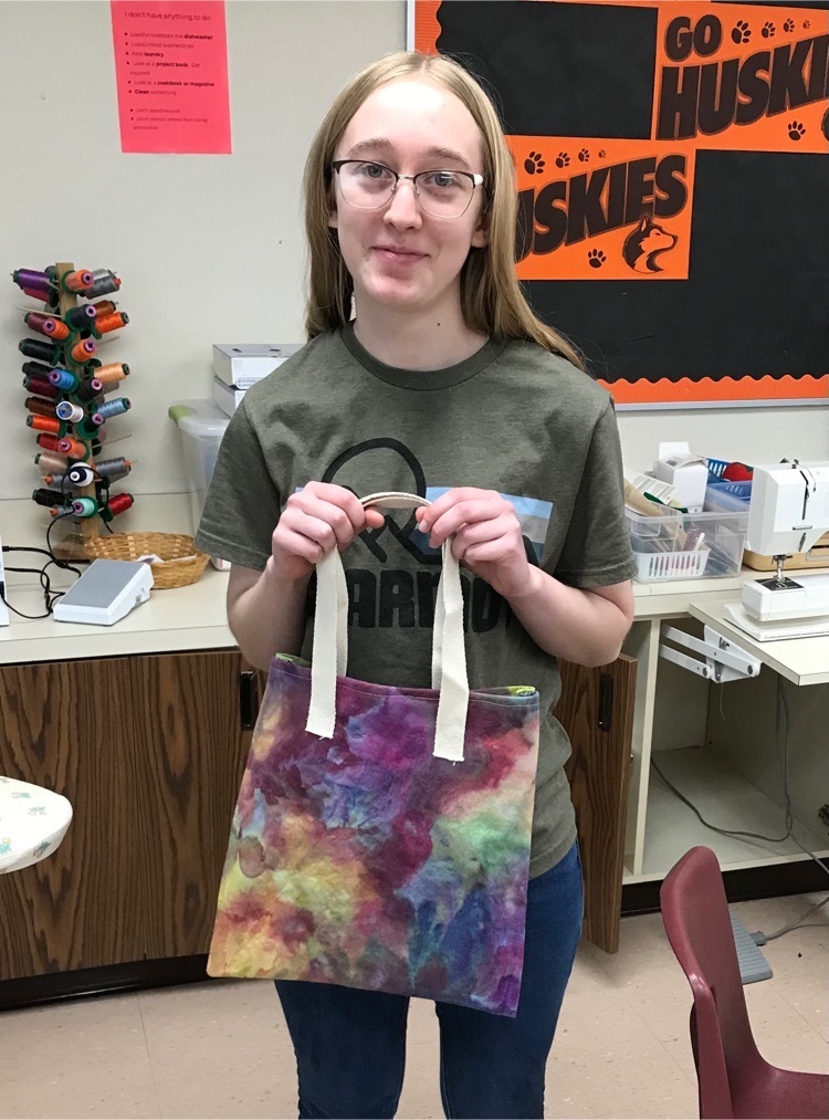 student holding dyed tote