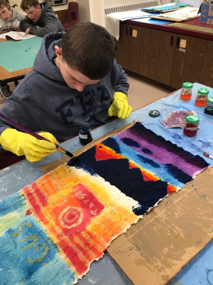 student painting fabric